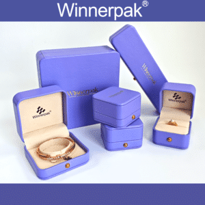 Purple leatherette jewelry box with rounded corners, gold snap button and custom logo for wholesale jewelry packaging