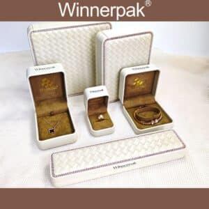 Premium RS04 round corner leatherette jewelry box with woven texture and pink diamond chain inlay.